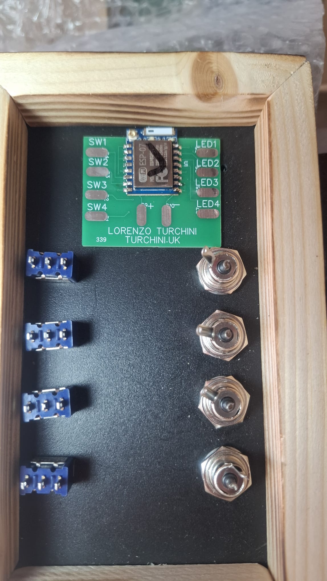 Inside the Turing Box — custom PCB, toggle switches and LED connectors neatly arranged before wiring